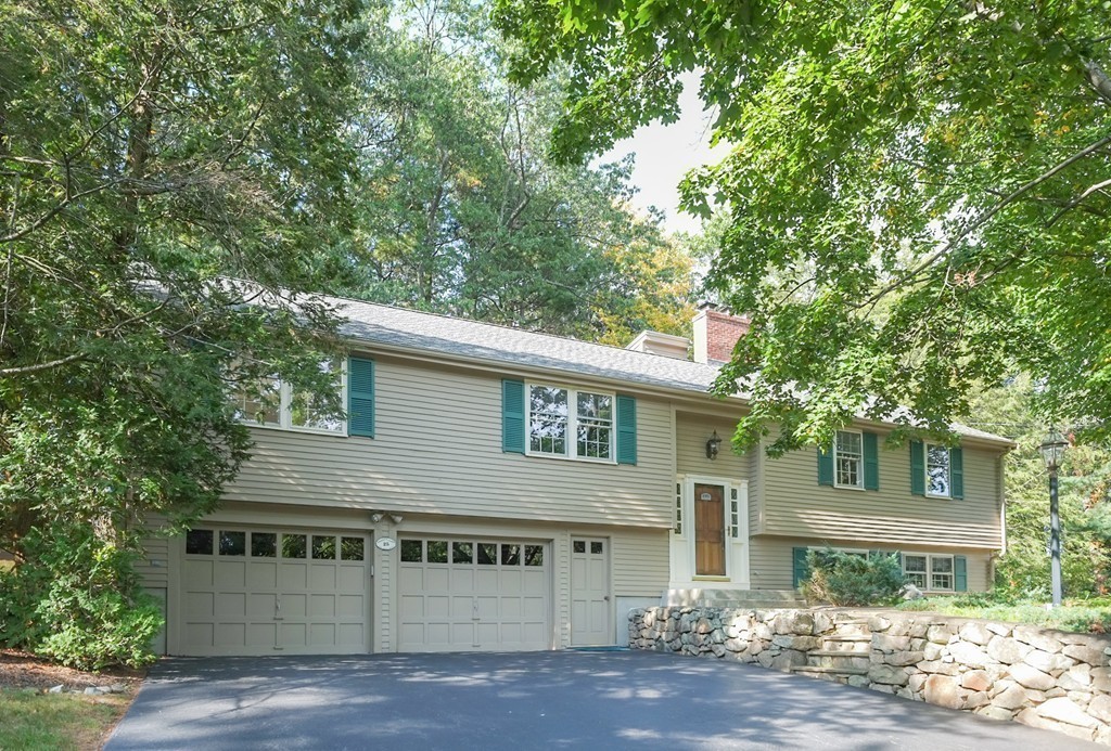 25 Oak Hill Road Wayland, MA 01778 - Photo 28 of 30 a view of a white house with large windows and a tree