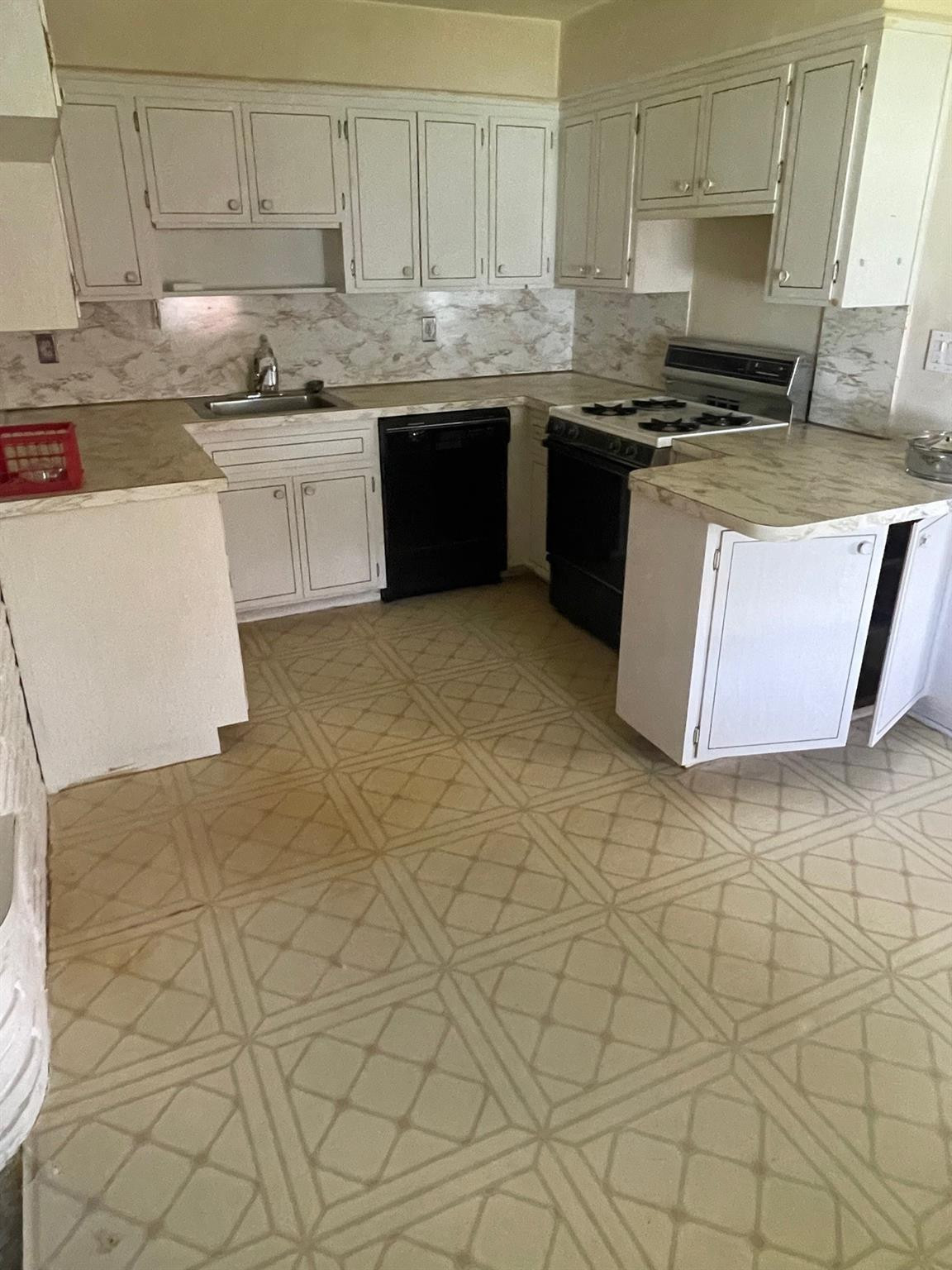 930 North 31st Road Hollywood, FL 33021 - Photo 3 of 8 a kitchen with granite countertop white cabinets and stainless steel appliances