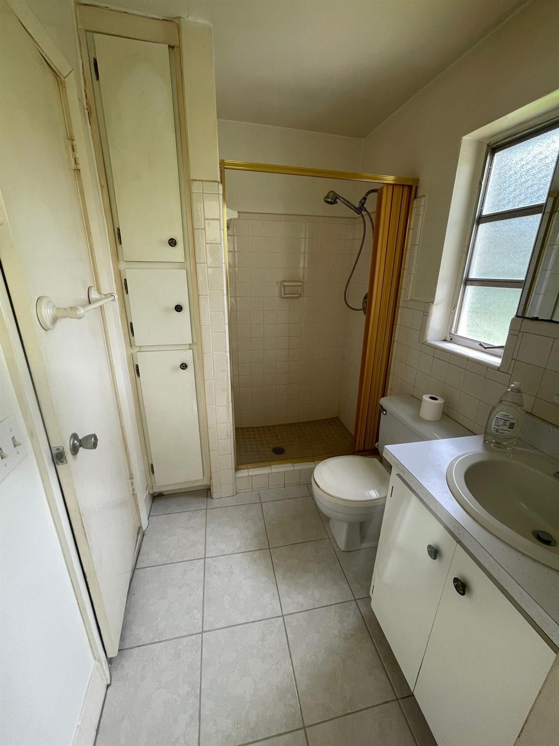 930 North 31st Road Hollywood, FL 33021 - Photo 6 of 8 a bathroom with a granite countertop sink toilet and shower