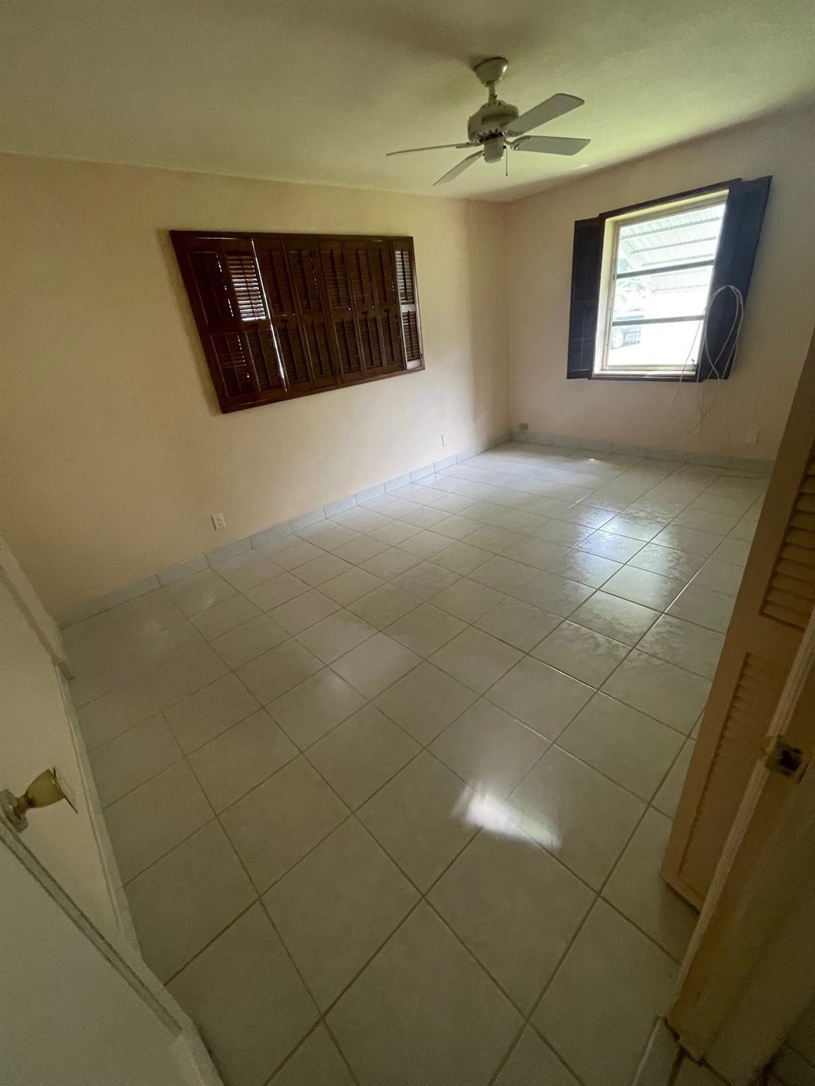 930 North 31st Road Hollywood, FL 33021 - Photo 8 of 8 en empty room with windows and ceiling fan