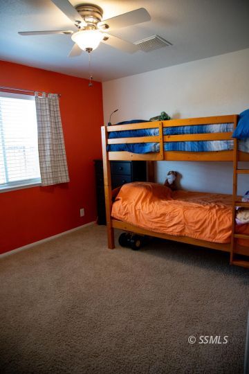 1017 Porter Street Ridgecrest, CA 93555 - Photo 11 of 15 a bedroom with a bed and window