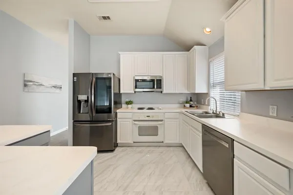 a view of a kitchen and dining room