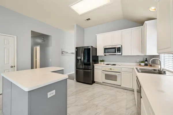 a kitchen with a refrigerator stove and microwave