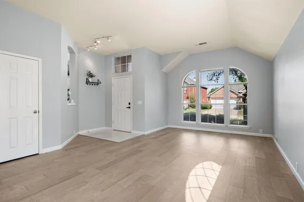 wooden floor in an empty room with a window