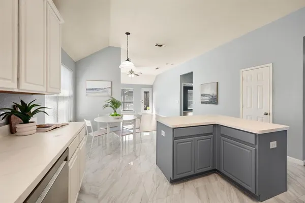 a kitchen with stainless steel appliances granite countertop a sink and a stove