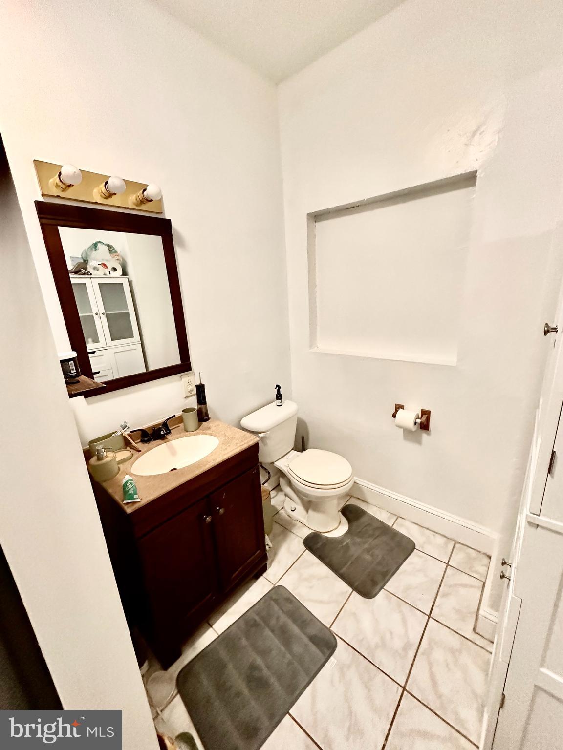 3339 Conrad Street, Unit 1 Philadelphia, PA 19129 - Photo 11 of 13 a view of bathroom with a toilet sink and mirror