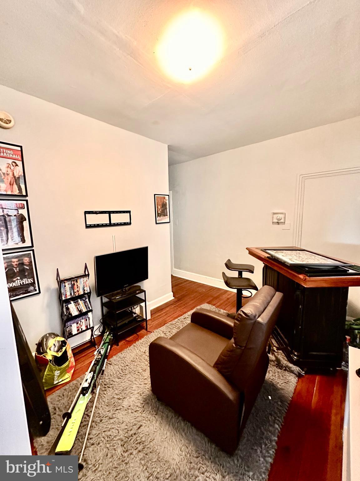 3339 Conrad Street, Unit 1 Philadelphia, PA 19129 - Photo 12 of 13 a living room with furniture a flat screen tv and a fireplace