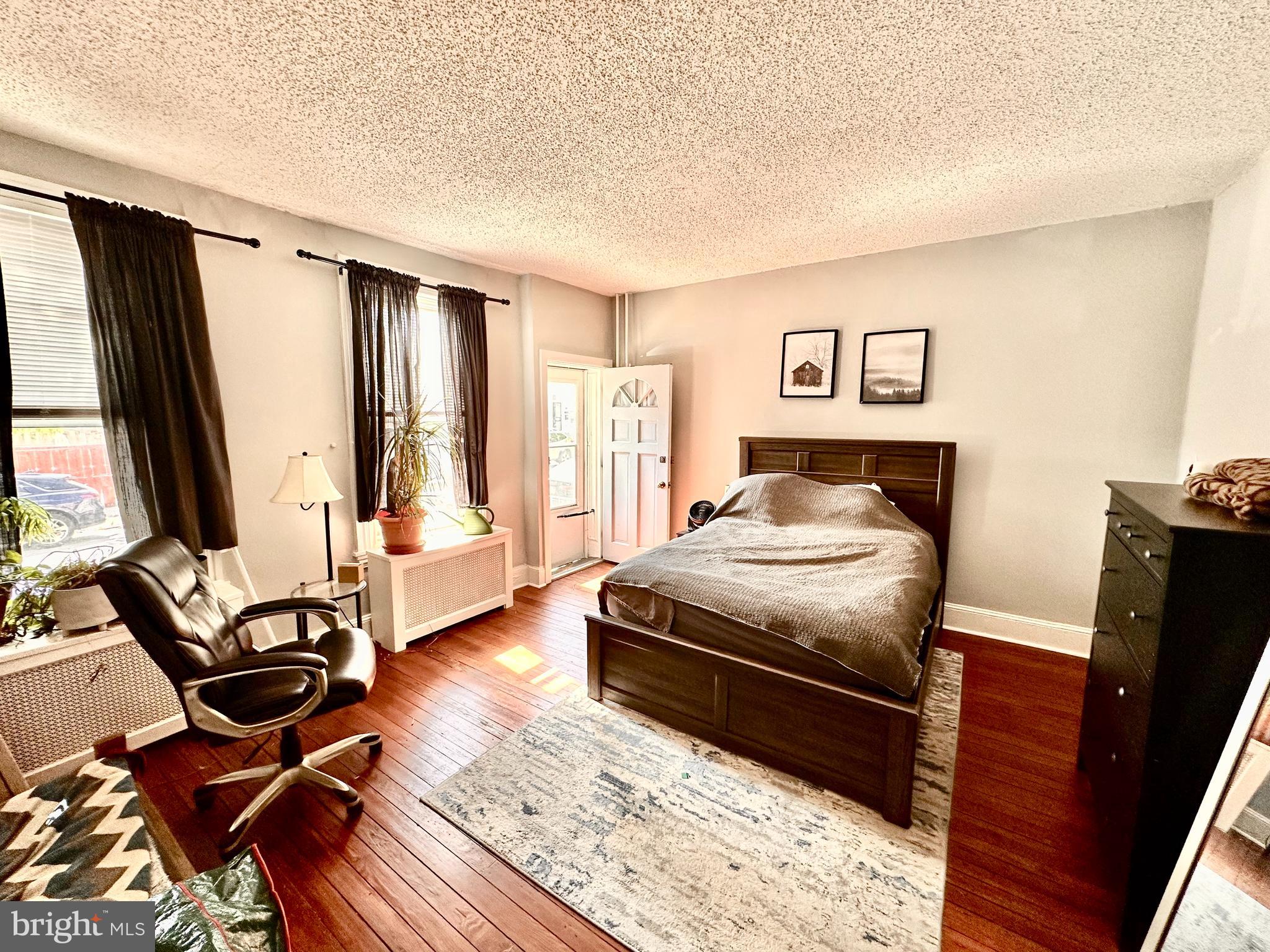 3339 Conrad Street, Unit 1 Philadelphia, PA 19129 - Photo 7 of 13 a bedroom with a bed and wooden floor