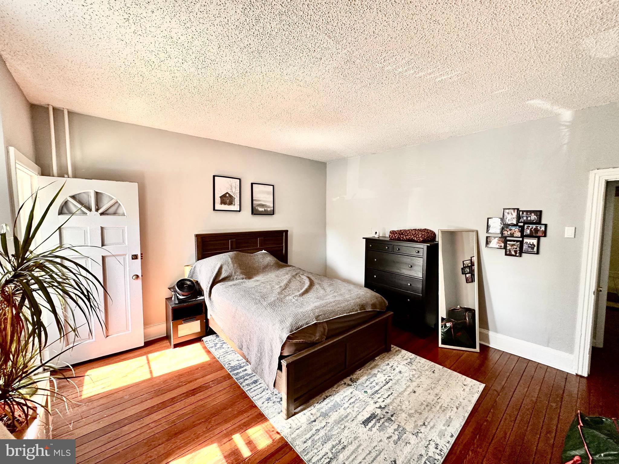 3339 Conrad Street, Unit 1 Philadelphia, PA 19129 - Photo 8 of 13 a bedroom with a bed and wooden floor