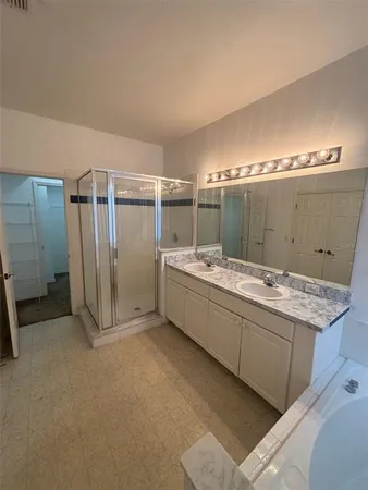 a bathroom with a glass shower door