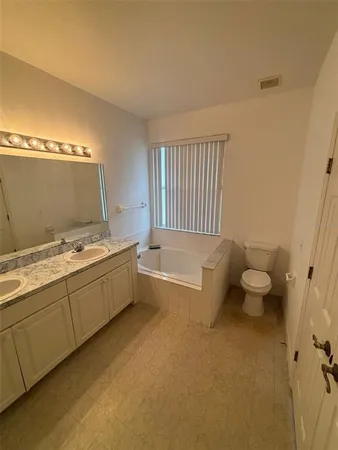 a bathroom with a bathtub a sink and a shower