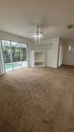 a view of empty room with window and front door