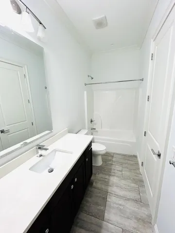 a bathroom with a sink a mirror and a shower