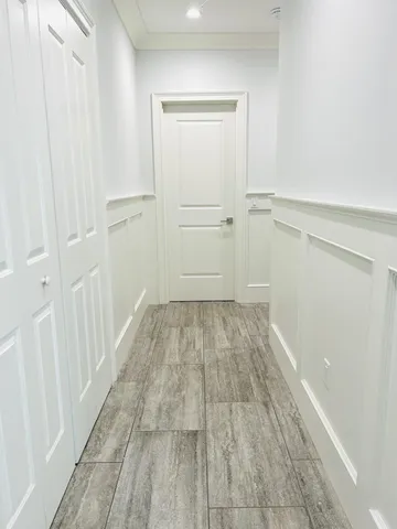 a view of a porch with furniture and floor to ceiling window