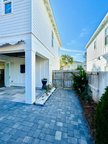 a view of a porch with furniture and garden