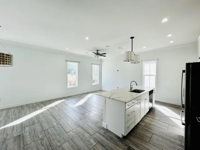 a view of a kitchen with a sink dishwasher a refrigerator and a stove
