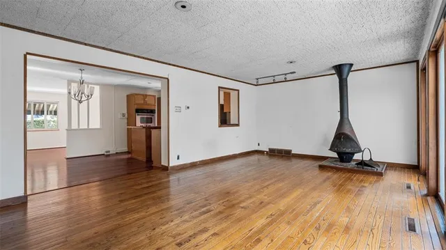 a view of a room with wooden floor and windows