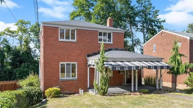 a view of a house with backyard porch and sitting area