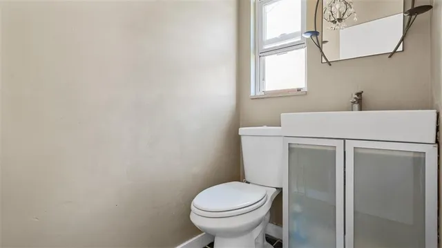 a bathroom with a sink toilet and window