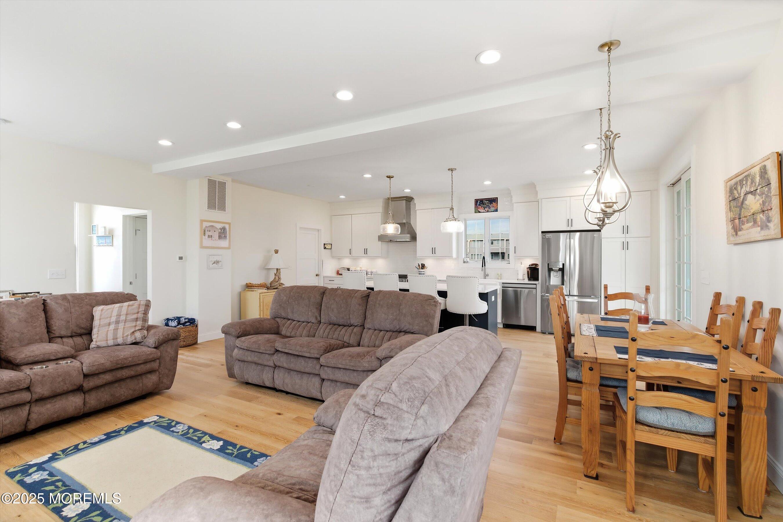 7 East Lavenia Avenue Beach Haven, NJ 08008 - Photo 11 of 48 a living room with furniture kitchen view and a chandelier