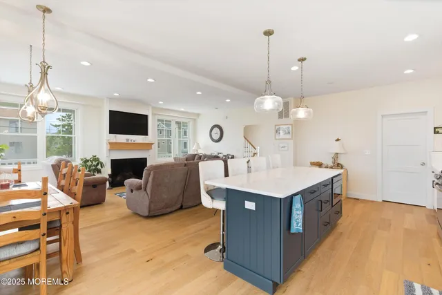 a view of living room with kitchen island furniture and flat screen tv