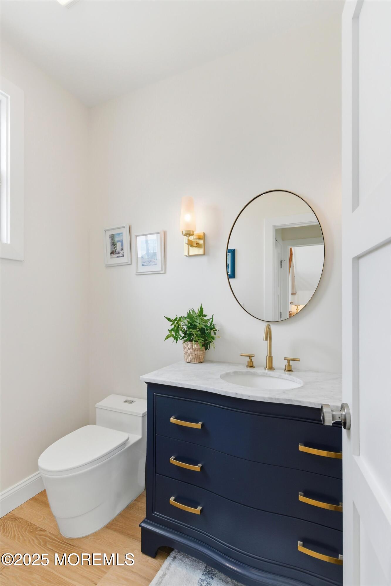 7 East Lavenia Avenue Beach Haven, NJ 08008 - Photo 18 of 48 a living room with a mirror and a potted plant