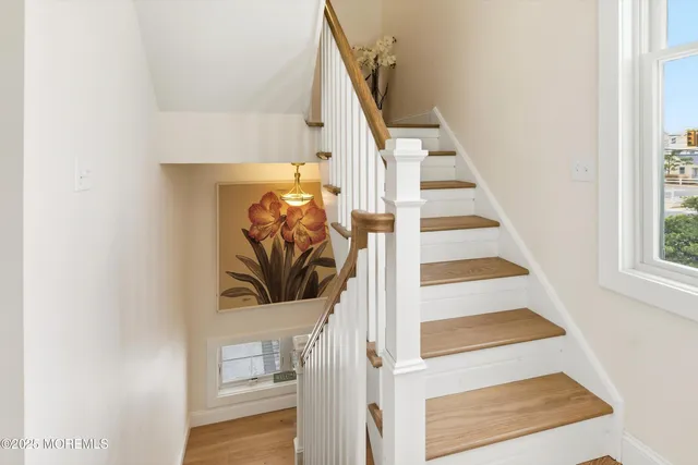 a view of entryway and hall with wooden floor