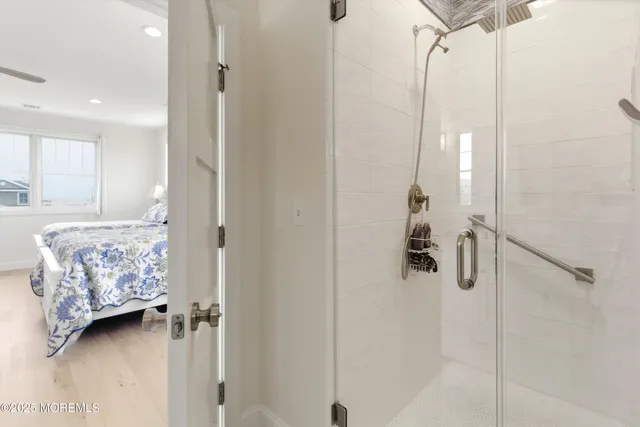 a view of a bedroom with a bed and a window