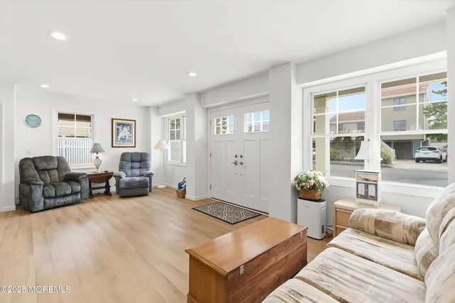 a living room with furniture and large window