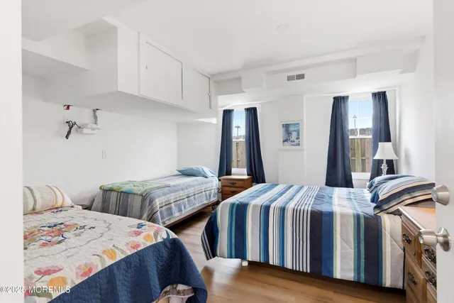 a bedroom with two beds and a dresser