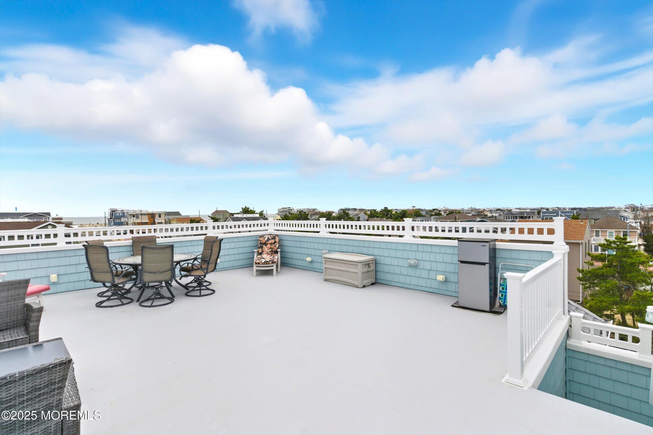 7 East Lavenia Avenue Beach Haven, NJ 08008 - Photo 32 of 48 a terrace with a bench and city view