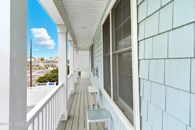 a view of a balcony with wooden floor and staircase