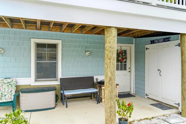 a balcony with furniture and a potted plant