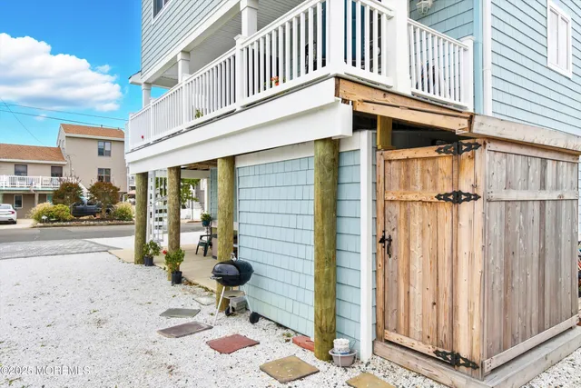 a backyard of a house with table and chairs