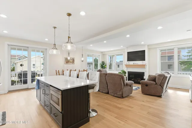 a large kitchen with stainless steel appliances kitchen island granite countertop a large island in the center