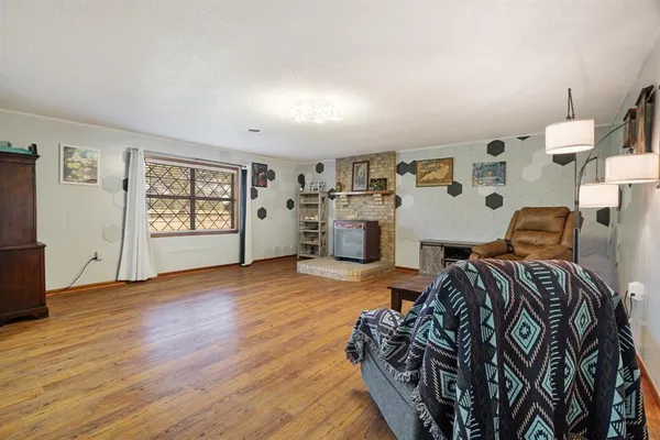 a view of a bedroom with wooden floor