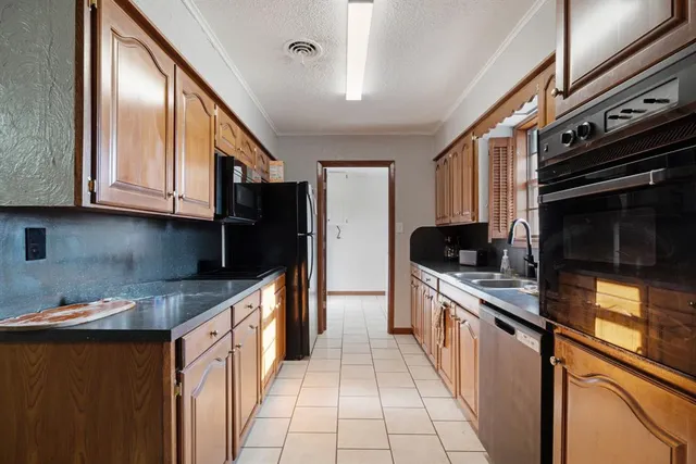 a kitchen with stainless steel appliances granite countertop a stove and a sink