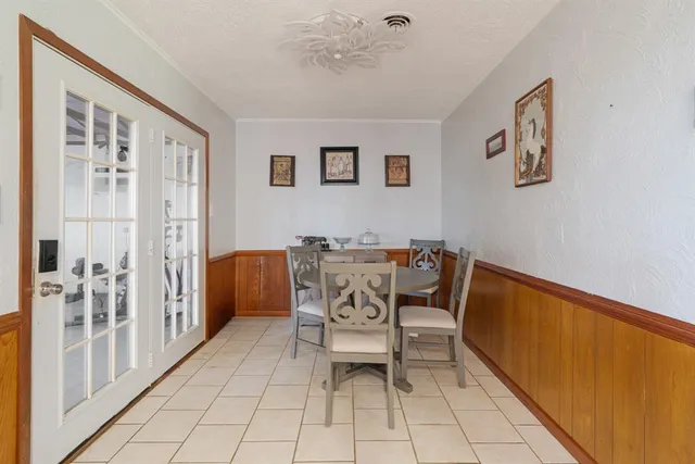 a dining room with furniture and window