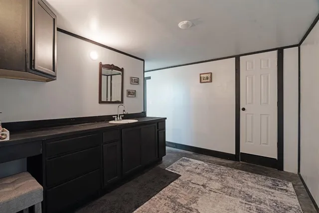 a room with painting on the wall and a window