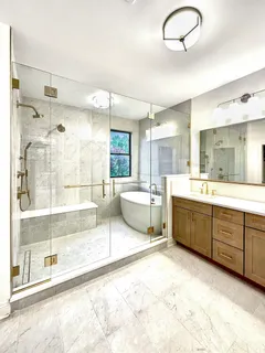 a large bathroom with a large tub shower sink and mirror