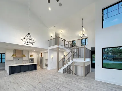 a view of a room with lots of wooden furniture and windows