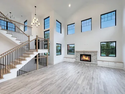 a view of a livingroom with wooden floor and a fireplace