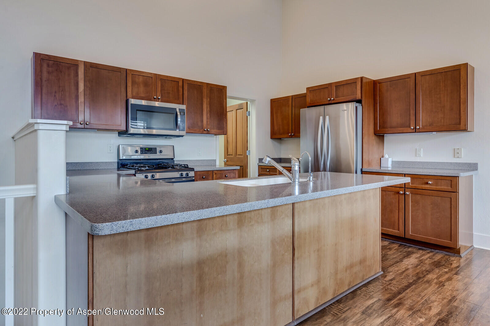 536 Evans Court Basalt, CO 81621 - Photo 5 of 19 a kitchen with stainless steel appliances granite countertop a sink a stove and a refrigerator with wooden cabinets