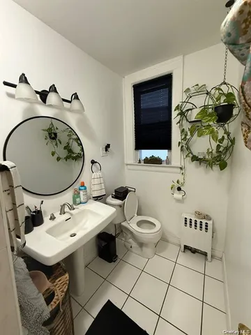 a bathroom with a sink a toilet and mirror