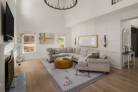 a living room with furniture a flat screen tv and a fireplace