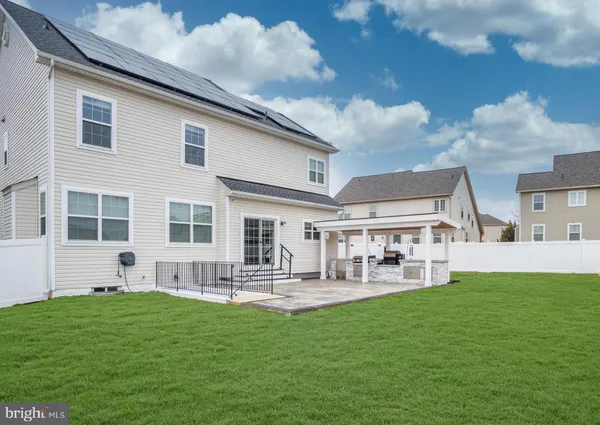 a front view of house with yard and outdoor seating