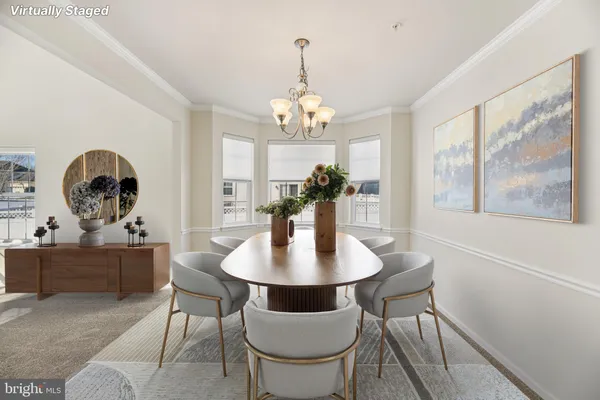 a view of a dining room with furniture a chandelier and wooden floor