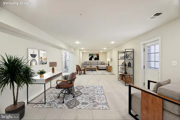 a living room with furniture and a potted plant