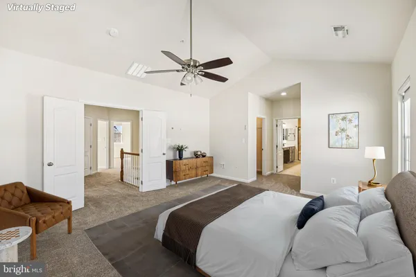 a bedroom with a bed couch and window