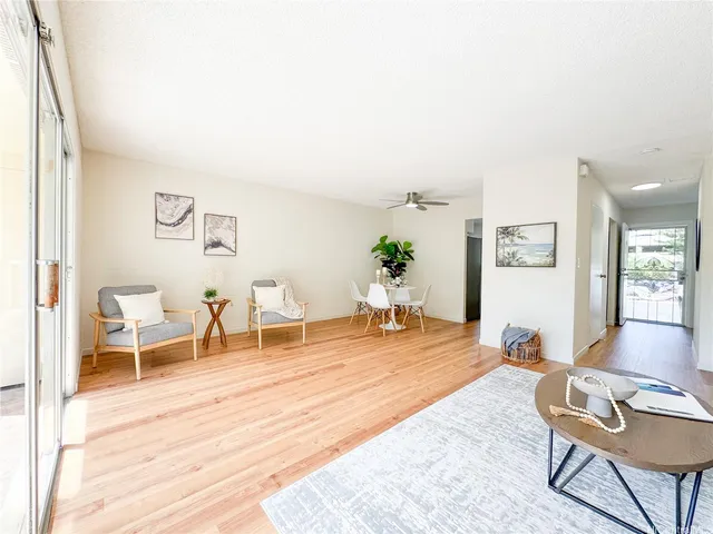 a living room with furniture and wooden floor